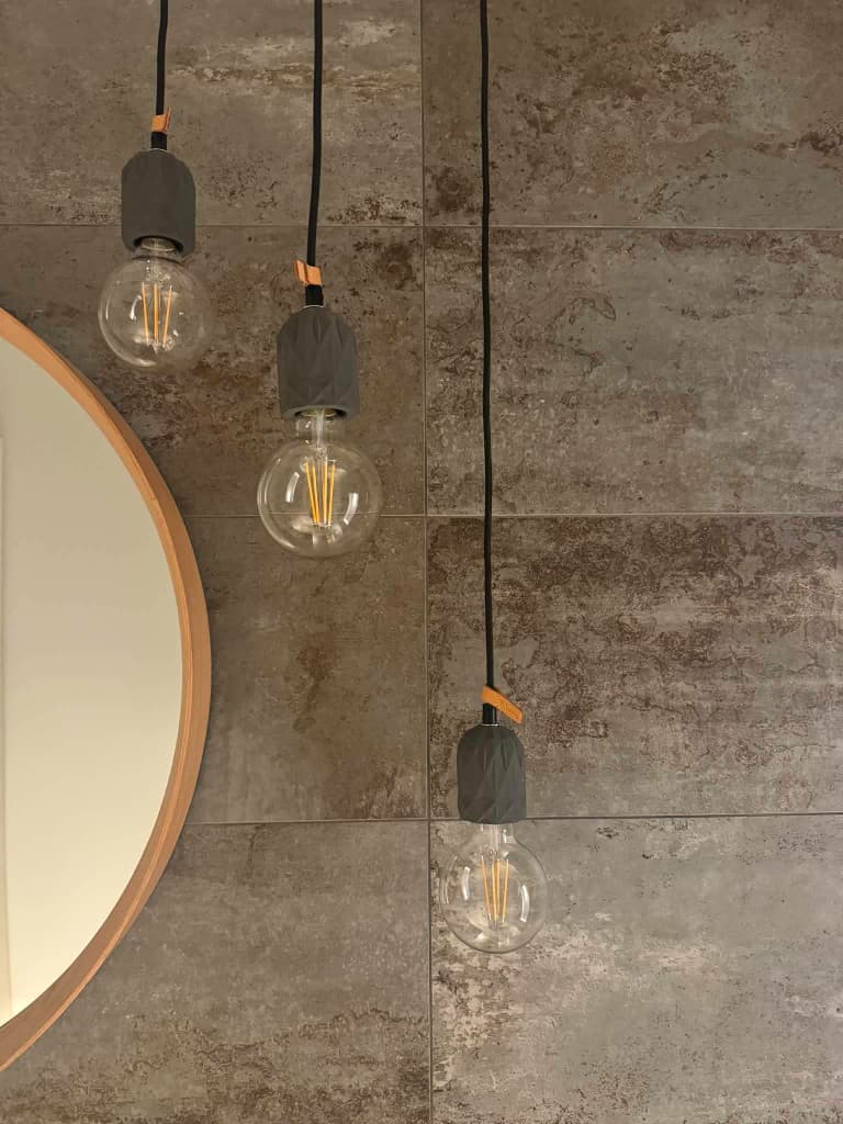 Feature pendant lighting above a tiled wall