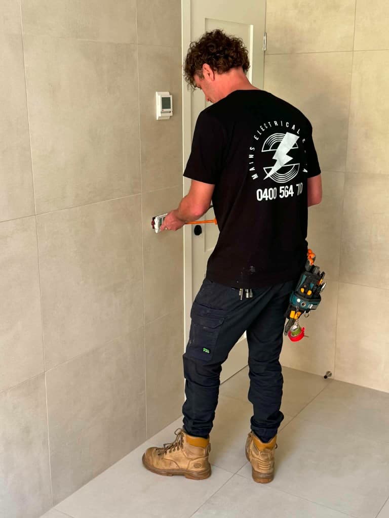 Electrician installing electrical fittings on site