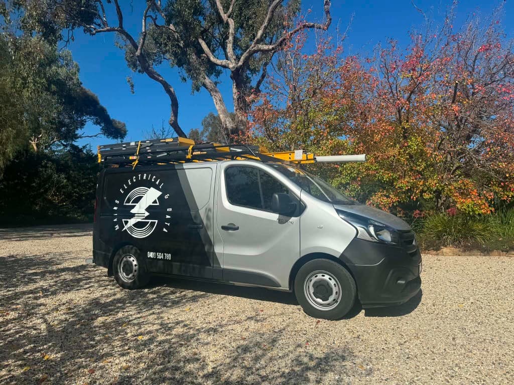 Mains Electrical service van with ladders on the roof rack
